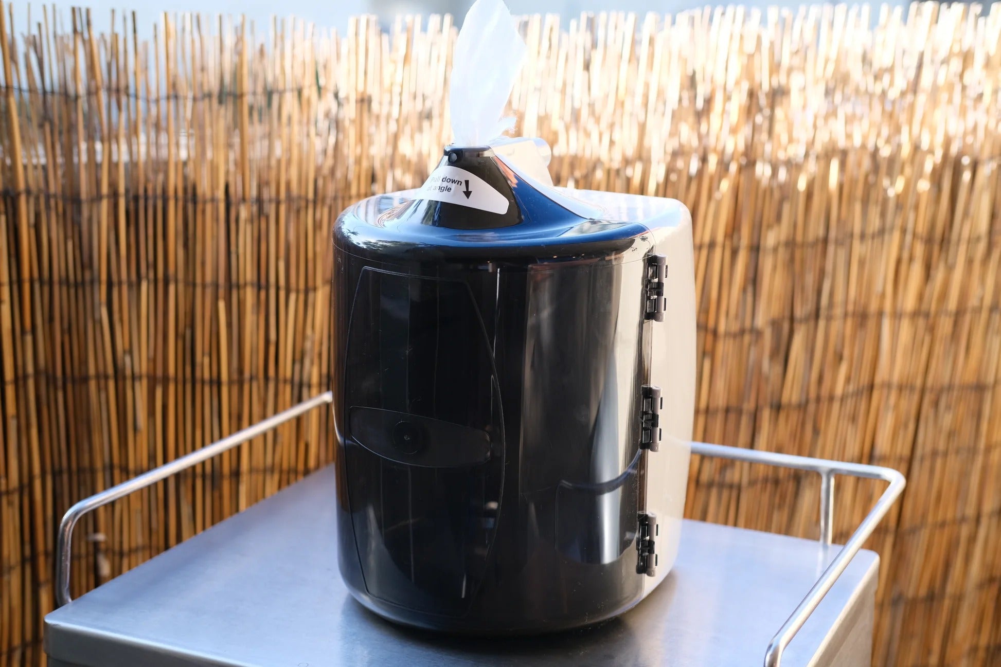 Side view of plastic wall wipe dispenser for gyms