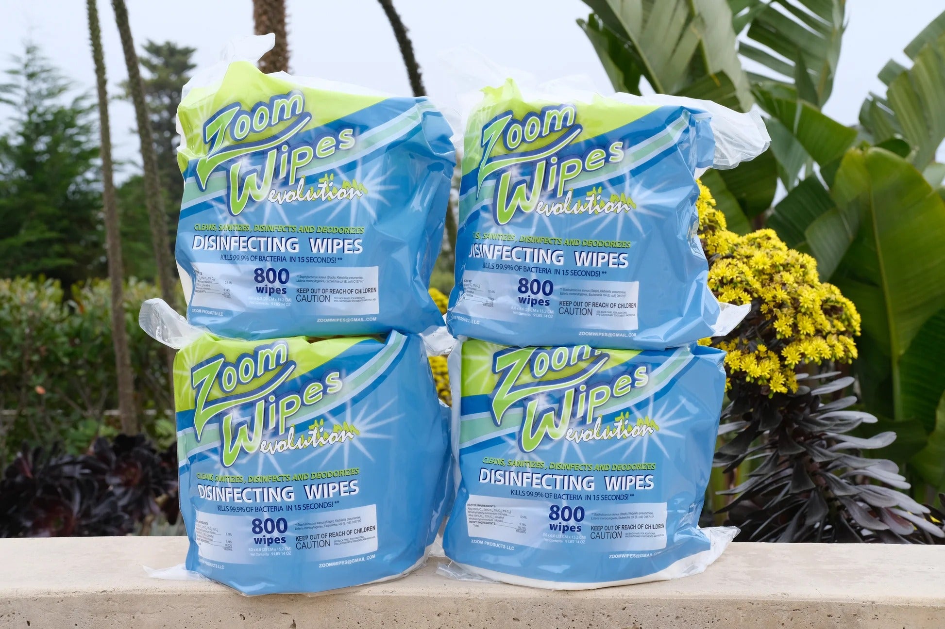 Pack of Zoom disinfecting wipes on a table with plants in the background